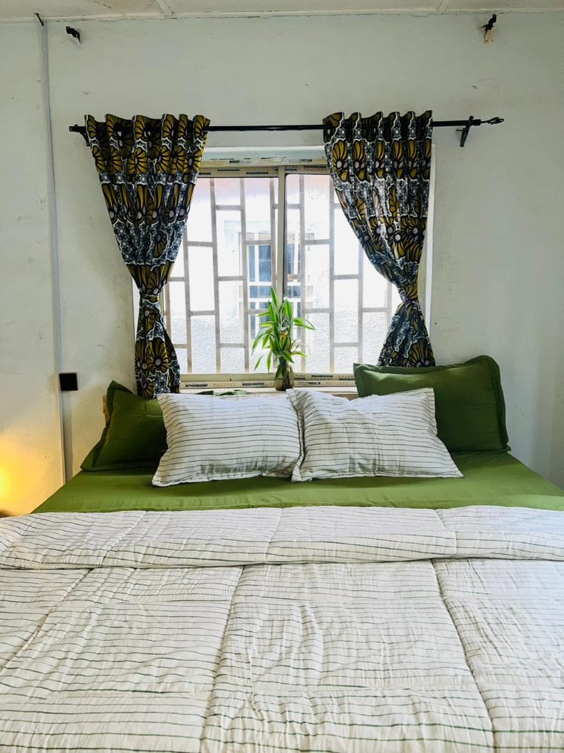 Bed with striped duvet and window view