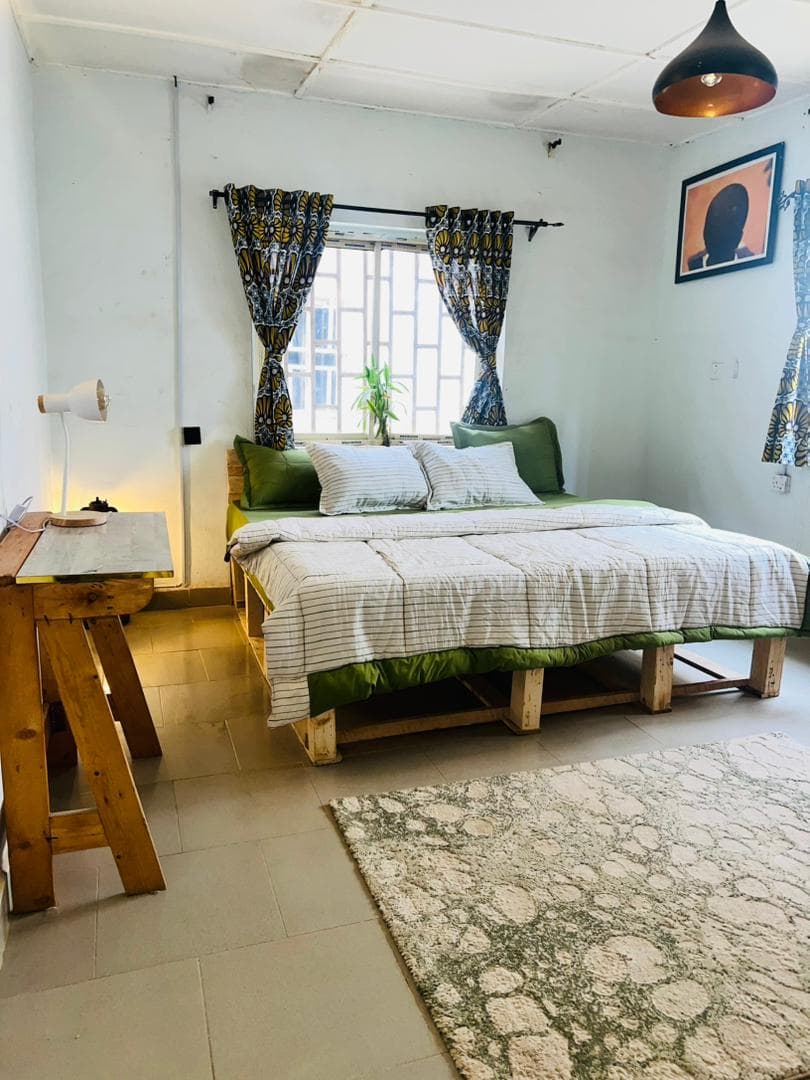 Bed area with rug and pendant light