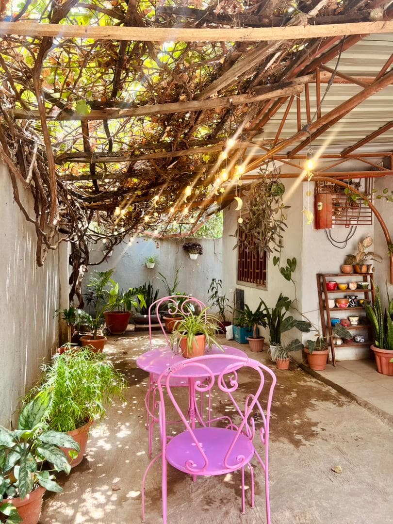 Outdoor patio with pink bistro set and string lights
